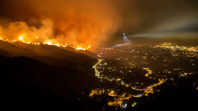 Rescue teams evacuating neighborhood from wildfire - time lapse