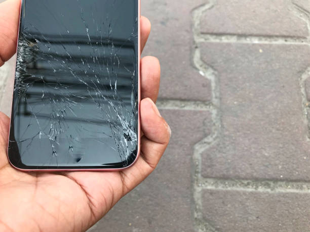 istock Smartphone screens break in the hand from falling ground and space agreement 870397764