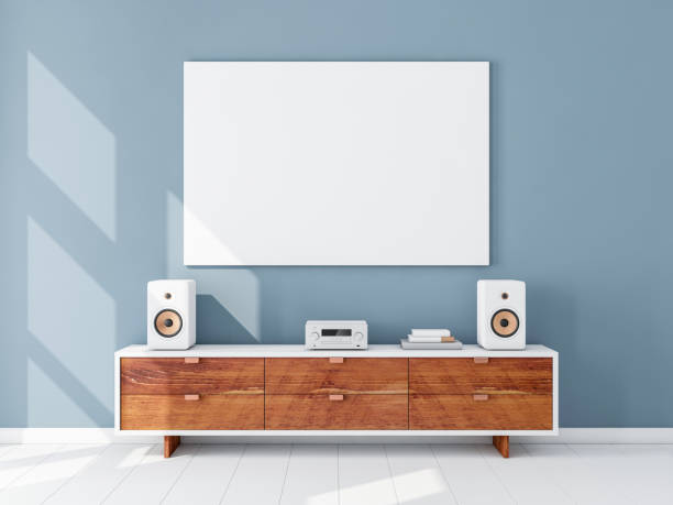 istock Horizontal white canvas Mockup hanging on the Blue wall with hi-fi micro system on bureau 870397800