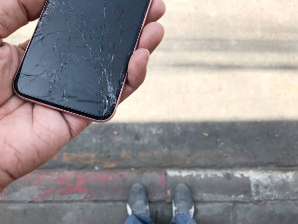 istock Smartphone screens break in the hand from falling ground and space agreement 870397896