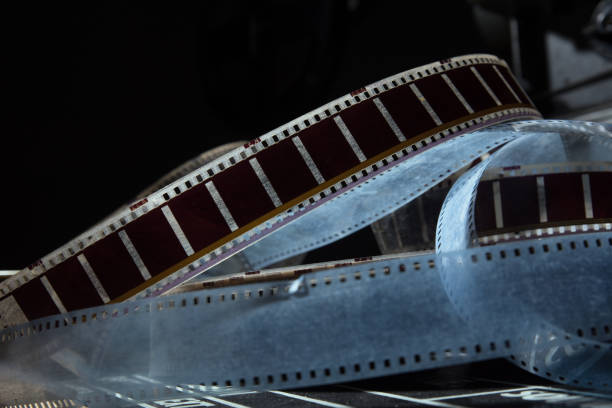 Old film with a movie on a dark background. The film lies on the movie cracker