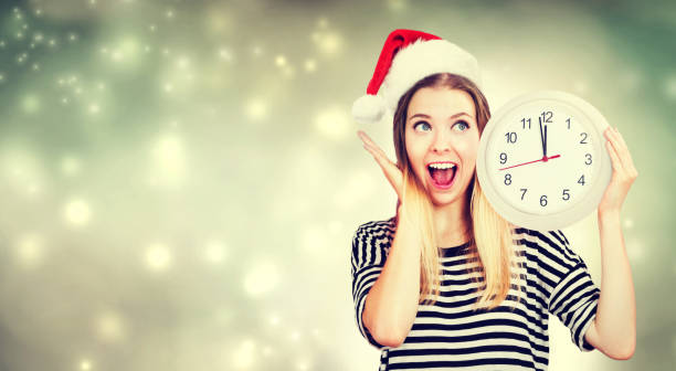 istock Woman holding clock showing nearly 12 870402482