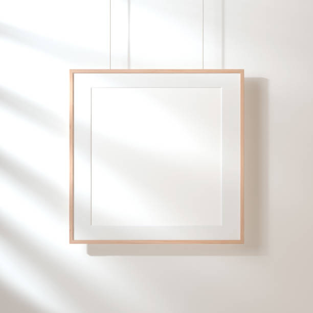 Square poster with wooden frame mockup hanging on the wall with shadows Square poster with wooden frame mockup hanging on the wall with shadows, 3d mat photos stock pictures, royalty-free photos & images