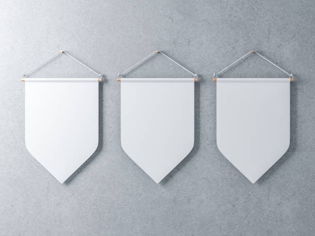 istock Three White pennants hanging on a concrete wall 870405374