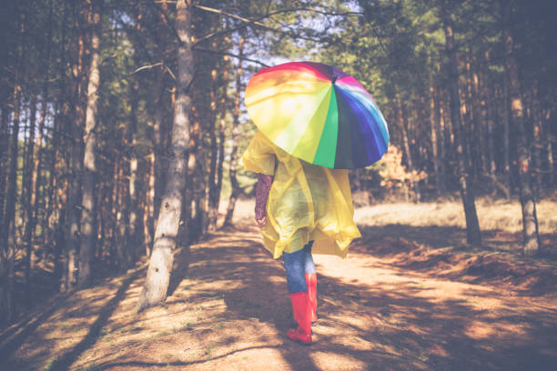 istock Woman with umbrella wearing rubber boots 870405978