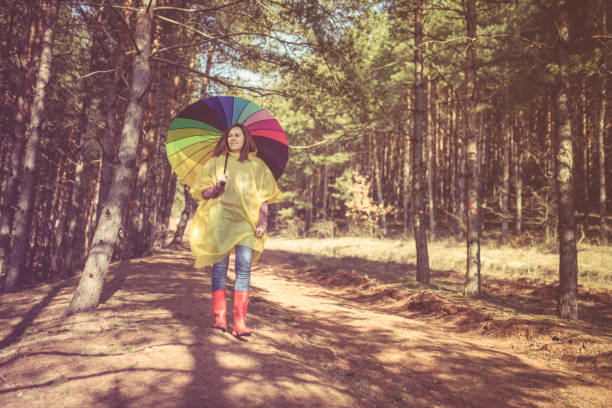 istock Woman with umbrella wearing rubber boots 870406186