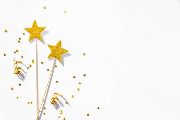istock Two golden party magic wands, sequins and ribbons on a white background. Copy space. 870408344