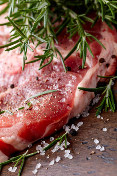 istock Raw pork with rosemary , salt and pepper. 870413018