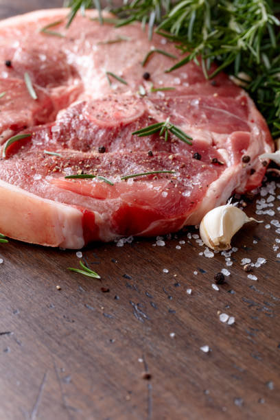 istock Raw pork with rosemary , salt and pepper. 870413034