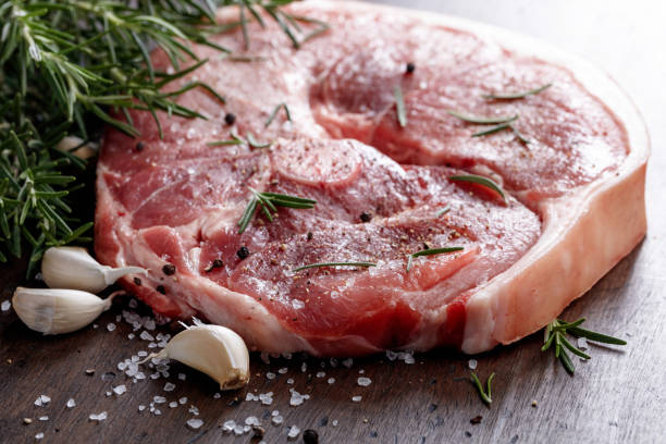 istock Raw pork with rosemary , salt and pepper. 870413046