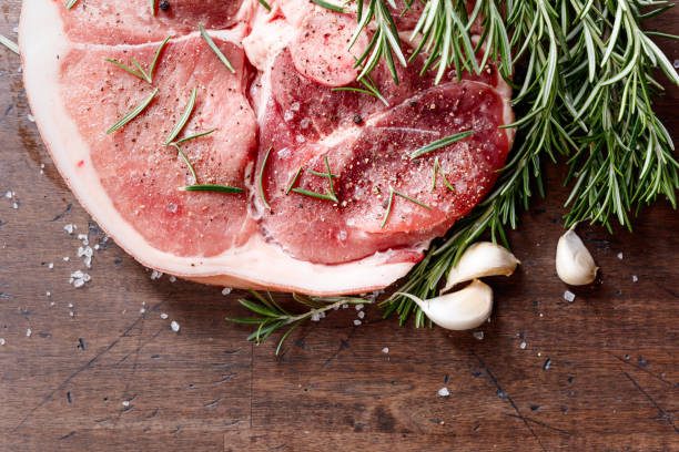 istock Raw pork with rosemary , salt and pepper. 870413058