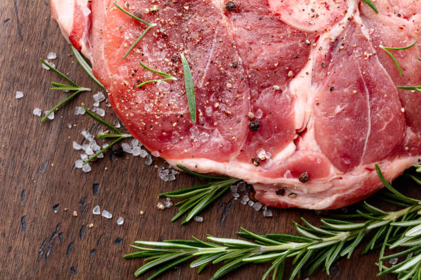 istock Raw pork with rosemary , salt and pepper. 870413076