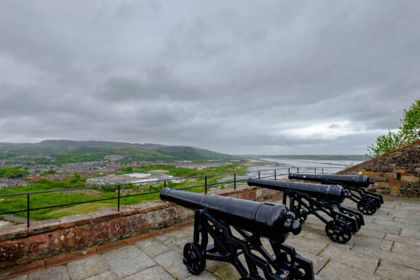 Dumbarton Castle, Scotland Cannons pointed towards the town of Dumbarton at the Dumbarton Castle, a medieval Scottish stronghold built on a plug of volcanic basalt occupied since the Iron Age. Not much survives from the medieval castle, being the existing structures built in the 18th century, but it is open to the public for stunning views. dumbarton castle stock pictures, royalty-free photos & images
