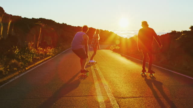 Friends Skateboarding at Sunset
