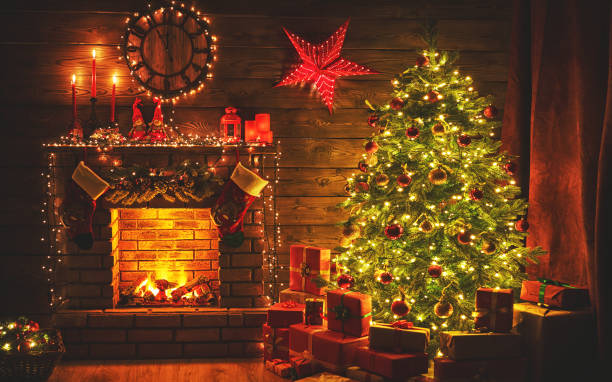 istock interior christmas. magic glowing tree, fireplace gifts in  dark 870426580