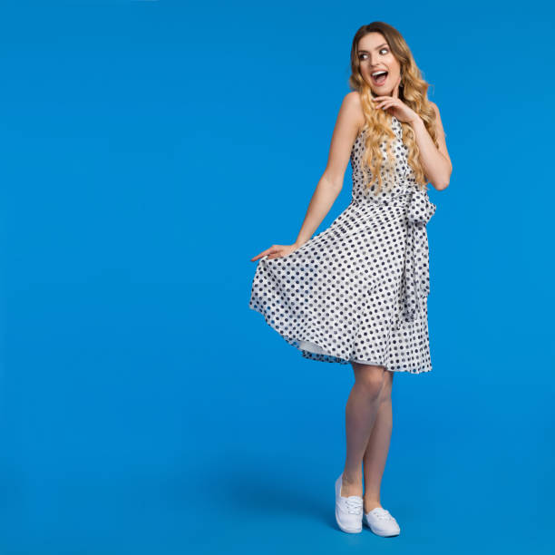 istock Excited Young Woman On Blue Background Is Looking Away And Shouting 870427432