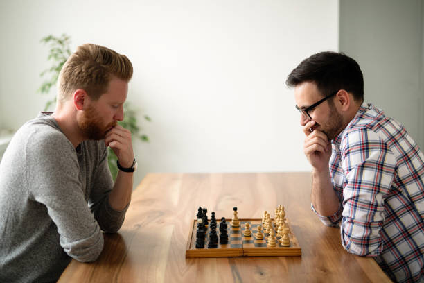 istock Portrait of two young man playing chess 870427718