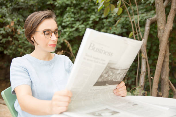 istock Businesswoman reading newspaper 870430274
