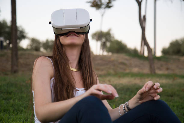 istock Young woman enjoying experience in VR glasses 870430742