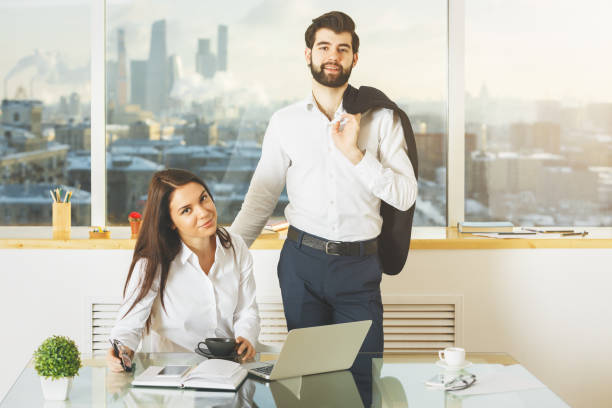 istock Happy male and female working together 870431302