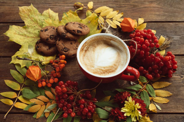 istock Cup of hot lattee on the autumn background 870435162