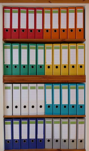 istock Colorful ring binders in a wooden shelf 870438350