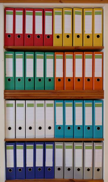 istock Colorful ring binders in a wooden shelf 870438406