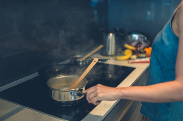 istock Young woman cooking in kitchen 870444784