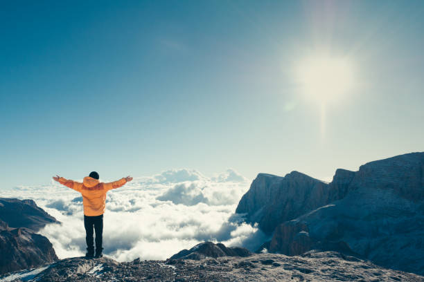 istock Man is open his arms while waching the beautiful scenery in the summit 870449350