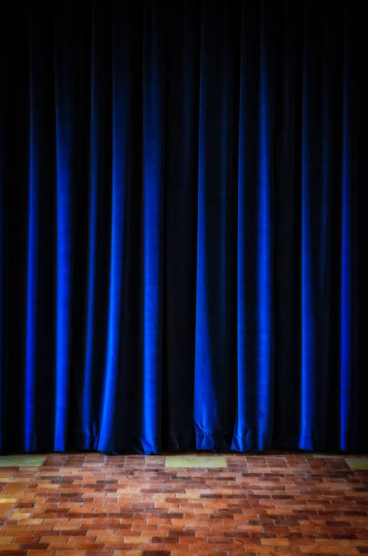 istock Colorful blue stage curtains and tiled floor 870450670