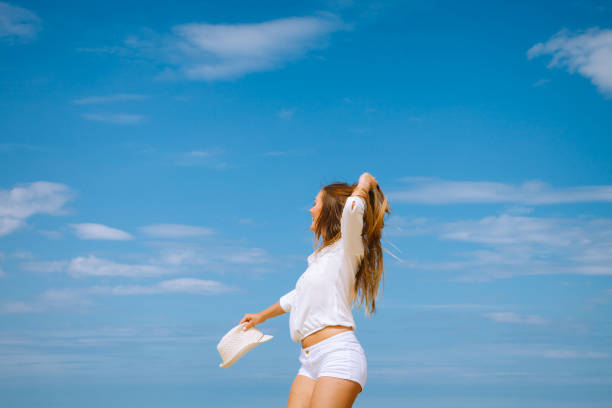 istock Happy woman on summer beach. 870450690