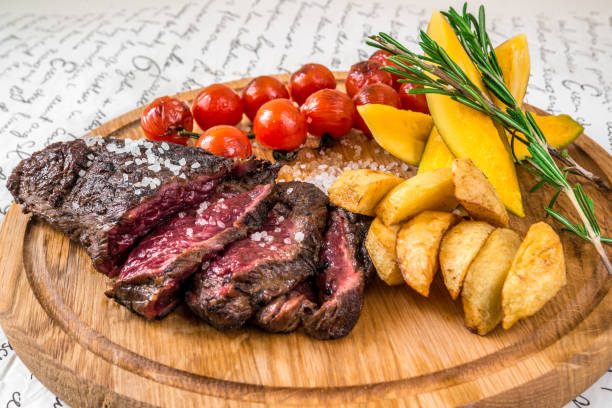 istock Mixed grilled meat, potatoes, tomatoes with herbs 870453508
