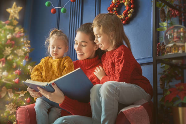 istock mother reading a book at Christmas 870456204