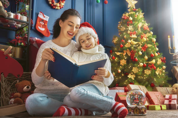 istock mother reading a book at Christmas 870456346