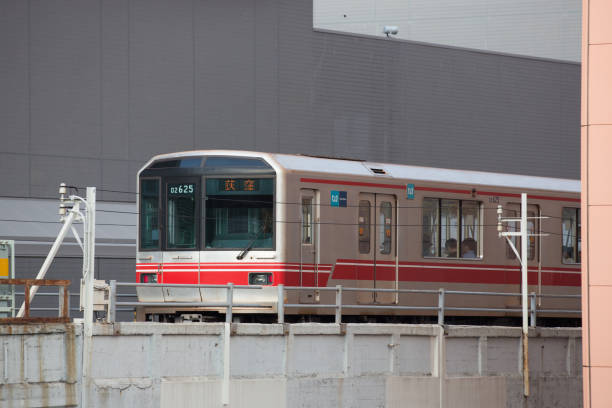 Tokyo, Japan - August 17, 2016: Tokyo Metro Marunouchi Line train move past the Korakuen Station in Tokyo, Japan.