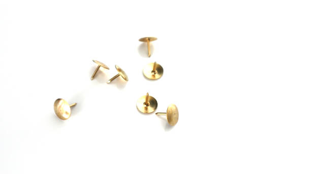 istock Gold push pins isolated on white background 870460692