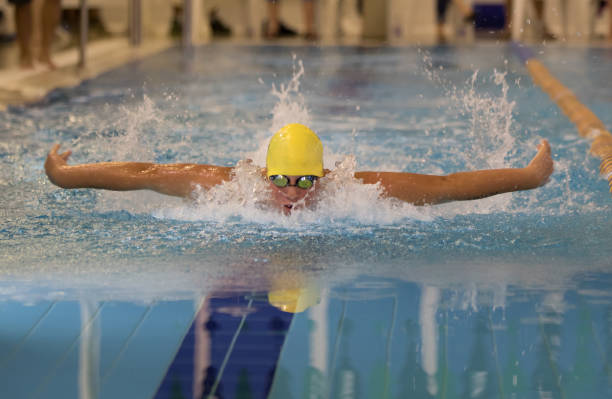 istock Young Boy showing determination in swim competition 870464224