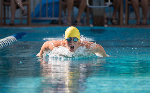 istock Young Boy showing determination in swim competition 870464226