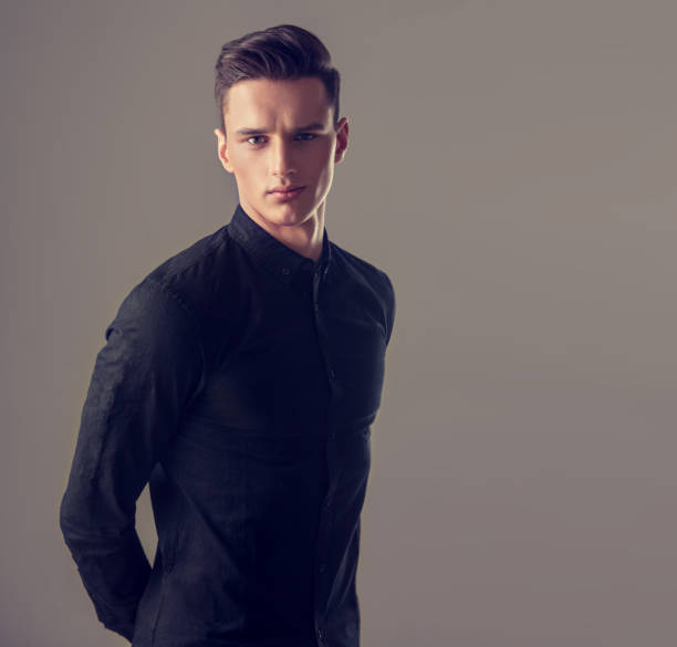 istock Handsome yong man dressed in a stylish  full buttoned black shirt . 870464442