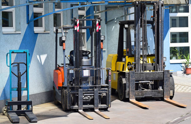 istock Forklifts in a row next to the warehouse 870471692