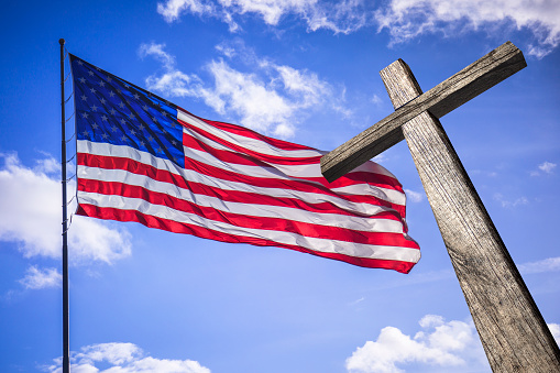 American flag with a wooden cross symbol of the blessed American nation.