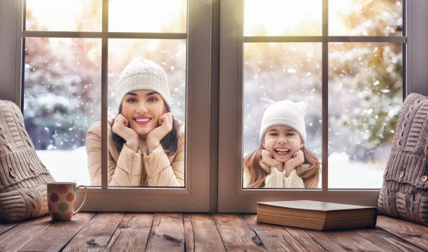 istock Child and mom looking in windows, standing outdoors 870474330