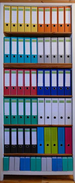 istock Colorful ring binders on a wooden shelf 870474990