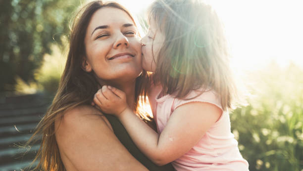 little girl with special needs enjoy spending time with mother - family child portrait little girls imagens e fotografias de stock