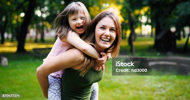 Little Girl With Special Needs Enjoy Spending Time With Mother Stock Photo - Download Image Now