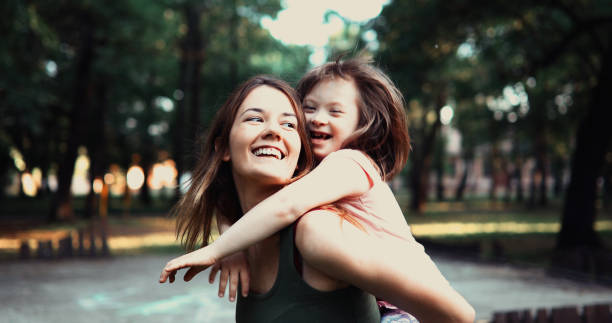 little girl with special needs enjoy spending time with mother - family child portrait little girls imagens e fotografias de stock