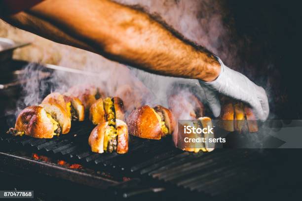 Hand Cooking Burgers On A Hot Flaming Grill Stock Photo - Download Image Now - Food Festival, Barbecue - Meal, Barbecue Grill