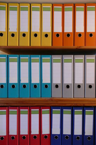 istock Colorful ring binders on a wooden shelf 870478424