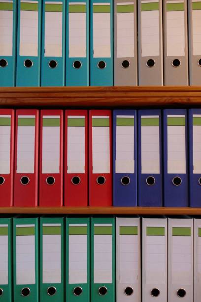 istock Colorful ring binders on a wooden shelf 870478506