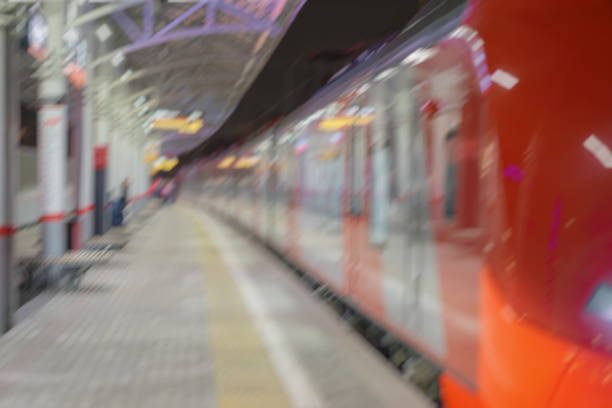 istock Railway station, platform at night, at dusk, passenger train stopped. Passenger transportation, style of life. Blurred background 870478540